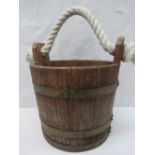 A vintage water bucket with brass bandin