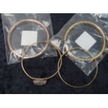 Four yellow metal bangles, one marked 92