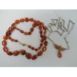 Two 'amber' necklaces. A white metal mod