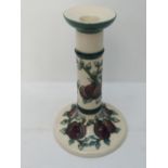 A Moorcroft tall candlestick in plum and