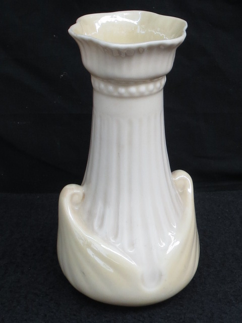 A green stamp Beleek fluted vase, tinted