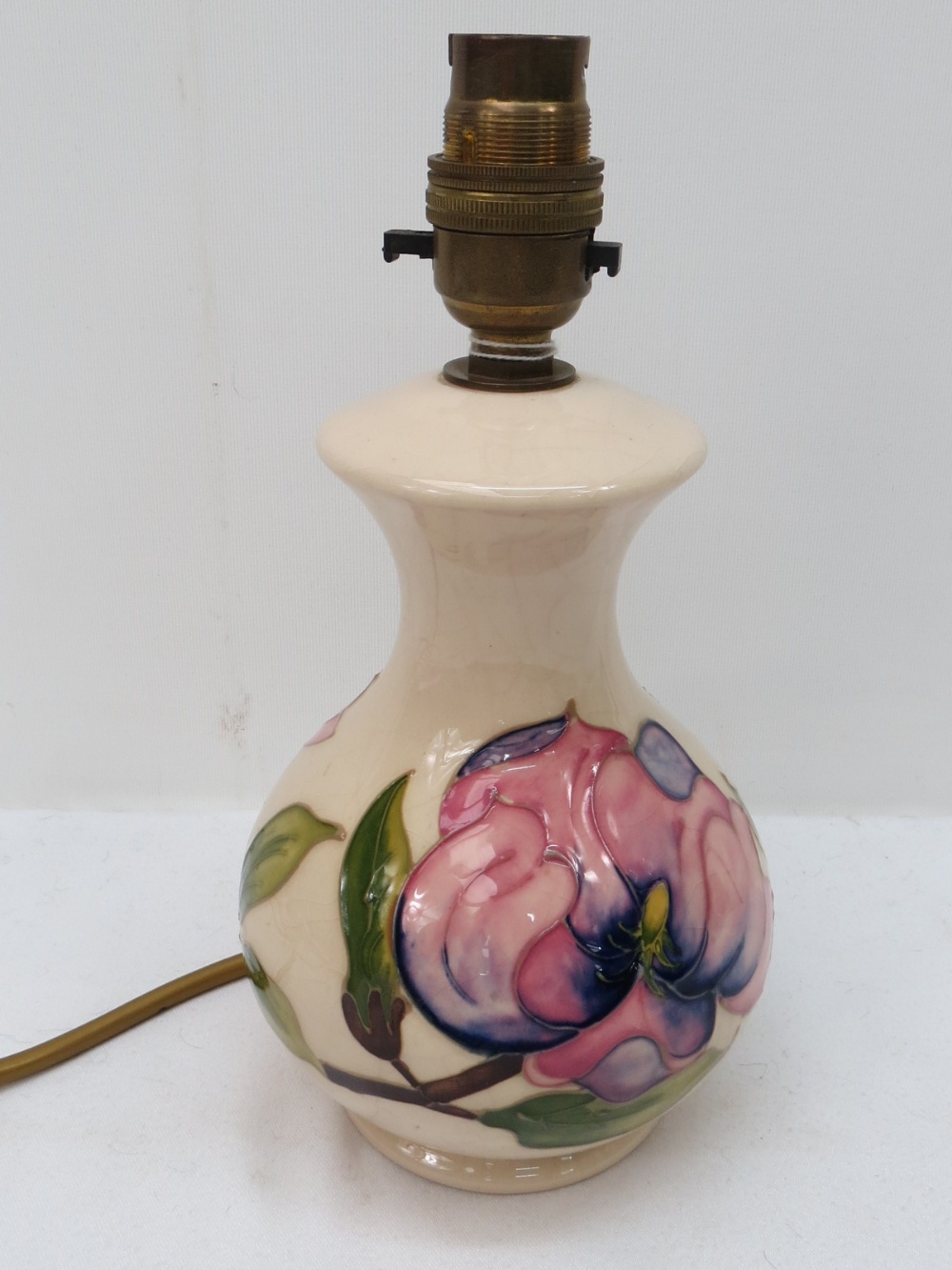 A Moorcroft table lamp with magnolia des