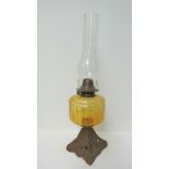 A late Victorian oil lamp with amber gla