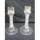 A pair of glass candlesticks with air tw