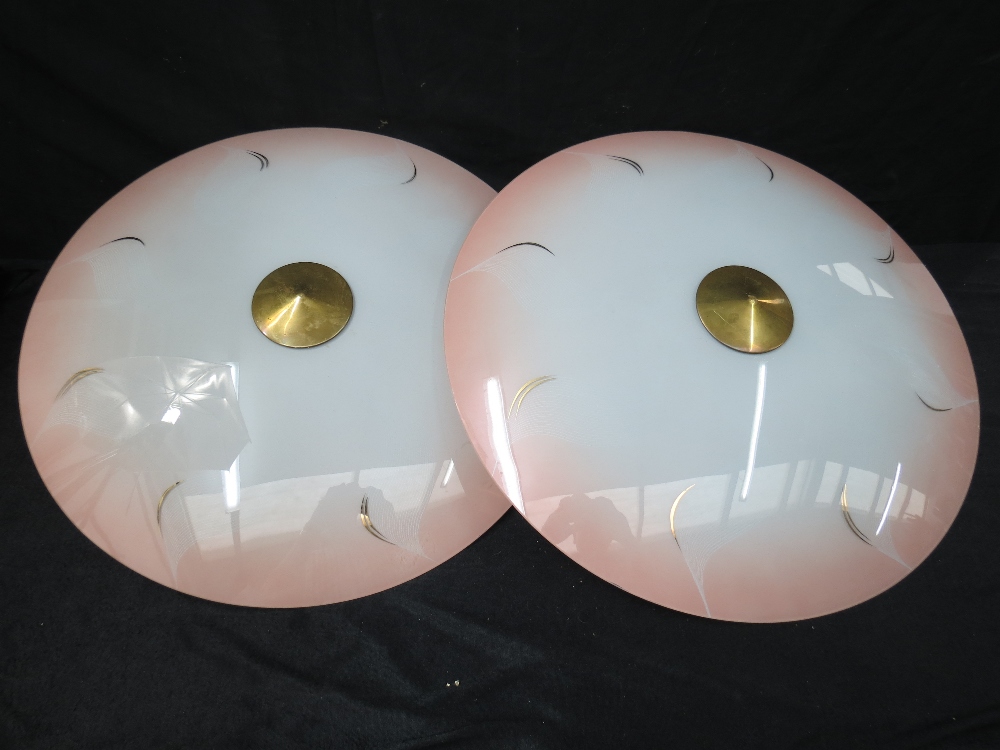 A pair of inverted glass lampshades with