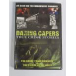 A DVD of Daring Capers True Crime Stories, signed by Ronnie Biggs.