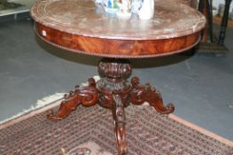 A 19TH.C.FLAME MAHOGANY MARBLE TOP CENTRE TABLE ON CARVED QUADROPED SUPPORT