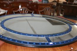 A LARGE OVAL ART DECO STYLE MARGINAL FRAMED MIRROR