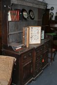 A GEO.III. OAK AND CROSSBANDED BREAKFRONT DRESSER WITH PLATE RACK OVER