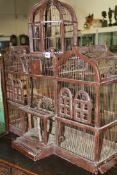 A VINTAGE PAINTED WOOD AND WIREWORK BIRDCAGE