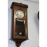 A MAHOGANY CASED CHIMING WALL CLOCK