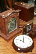 AN EDWARDIAN WALNUT CASED MANTLE CLOCK AND THREE BAKELITE CLOCKS