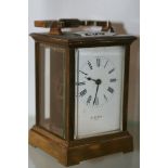 AN EDWARDIAN BRASS CASED CARRIAGE CLOCK WITH ENAMEL DIAL SIGNED H & W BIRD