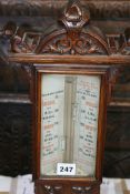 A VICTORIAN CARVED OAK CASED STICK BAROMETER