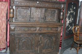 A 17TH.C.CARVED OAK COURT CUPBOARD