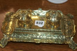 A VICTORIAN BRASS DESK INKWELL STAND