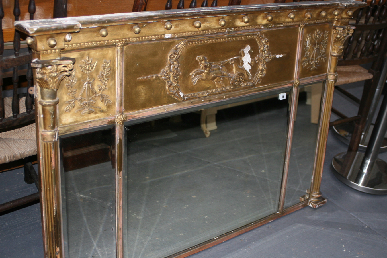 A REGENCY GILT OVERMANTLE MIRROR WITH TRIPLE BEVEL PLATES