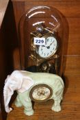 AN EDWARDIAN ANNIVERSARY CLOCK TOGETHER WITH A PORCELAIN CASED ELEPHANT FORM DESK CLOCK