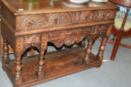 A SMALL CARVED OAK POTBOARD HALL TABLE