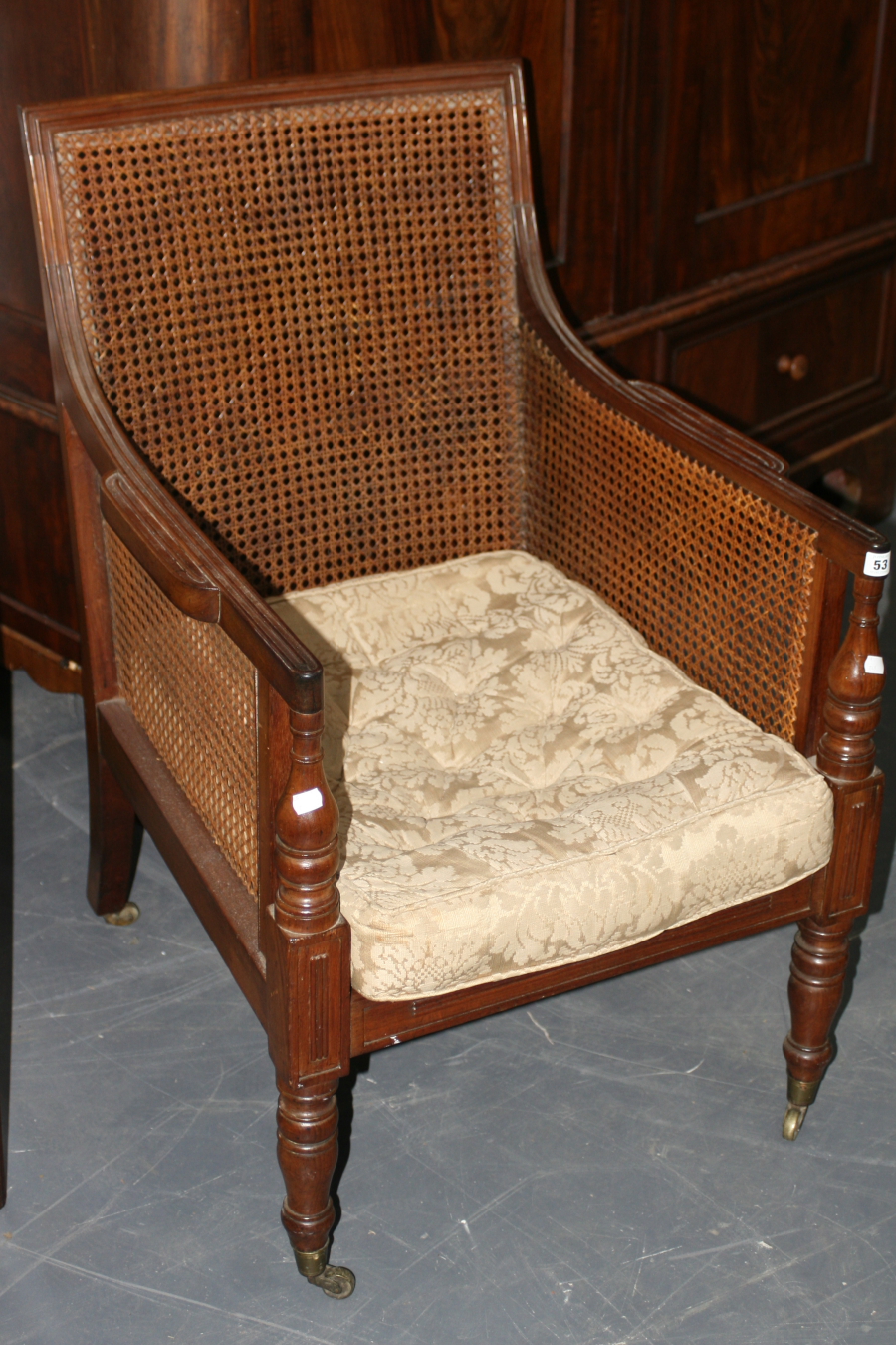 A 19TH.C.BERGERE LIBRARY ARMCHAIR