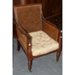 A 19TH.C.BERGERE LIBRARY ARMCHAIR