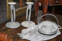 A PAIR OF ARCHIBALD KNOX DESIGN PEWTER CANDLESTICKS DESIGN NO 0223 AND A SIMILAR BASKET DESIGN NO