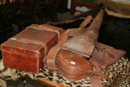 A GOOD QUALITY PIGSKIN CARTRIDGE BAG, A DOUBLE GUN CASE, A LEATHER MUTTON CASE AND A CARTRIDGE