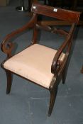 A REGENCY ARMCHAIR WITH SCROLL ARMS AND SABRE LEGS