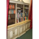 A BESPOKE PAINT DECORATED BREAKFRONT LIBRARY BOOKCASE
