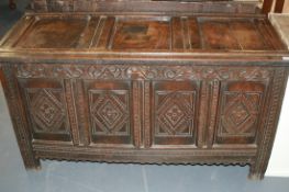 A 17TH.C.OAK CARVED FOUR PANEL COFFER