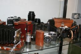 A COLLECTION OF CAMERAS AND BINOCULARS