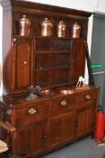 AN 18TH.C.OAK DRESSER BASE WITH PANEL DOORS AND ASSOCIATED PLATED RACK OVER