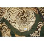 A LEOPARD SKIN RUG WITH ARMY AND NAVY NATURALIST'S LABEL