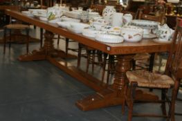 A LARGE AND IMPRESSIVE BESPOKE OAK REFECTORY TABLE WITH TURNED TRESTLE SUPPORTS AND A PAIR OF