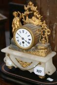 A VICTORIAN MARBLE AND GILDED METAL MANTLE CLOCK WITH EBONISED STAND