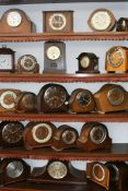 TWENTY TWO VARIOUS EARLY TO MID 20TH.C.OAK AND WALNUT CASED STRIKING MANTLE CLOCKS