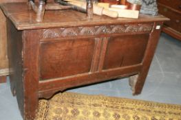 AN EARLY 18TH.C.OAK COFFER WITH CARVED FRIEZE AND MOULDED EDGE PLANK TOP