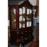 AN EARLY 19TH.C.DUTCH MAHOGANY BOMBE FORM CABINET ON CHEST