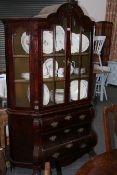 AN EARLY 19TH.C.DUTCH MAHOGANY BOMBE FORM CABINET ON CHEST