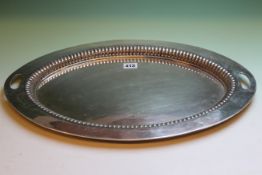 A SILVER TWO HANDLED OVAL TRAY WITH DEEP RIBBED BORDER, SHEFFIELD 1900, 52cms X 36cms, 63ozs.