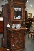 A VICTORIAN CARVED OAK BOOKCASE CABINET