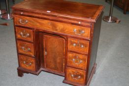 A GEO.III.MAHOGANY AND CROSS BANDED BATCHELOR'S KNEE HOLE DESK