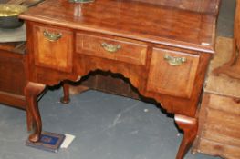 A WALNUT AND CROSS BANDED LOWBOY