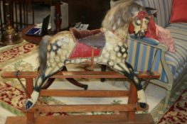 AN EARLY 20TH.C.CARVED WOOD ROCKING HORSE