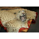 A LEOPARD SKIN RUG WITH MOUNTED HEAD