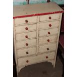 A RUSTIC PINE BANK OF DRAWERS