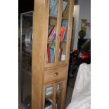 AN ANTIQUE GLAZED TALL PINE CABINET