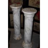 A PAIR OF CAST IRON PEDESTALS AND A PAIR OF COMPOSITE STONE HERALDIC LIONS