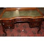 A CONTINENTAL MAHOGANY SERPENTINE FRONT WRITING TABLE