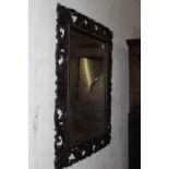 AN ANTIQUE CARVED OAK RECTANGULAR WALL MIRROR